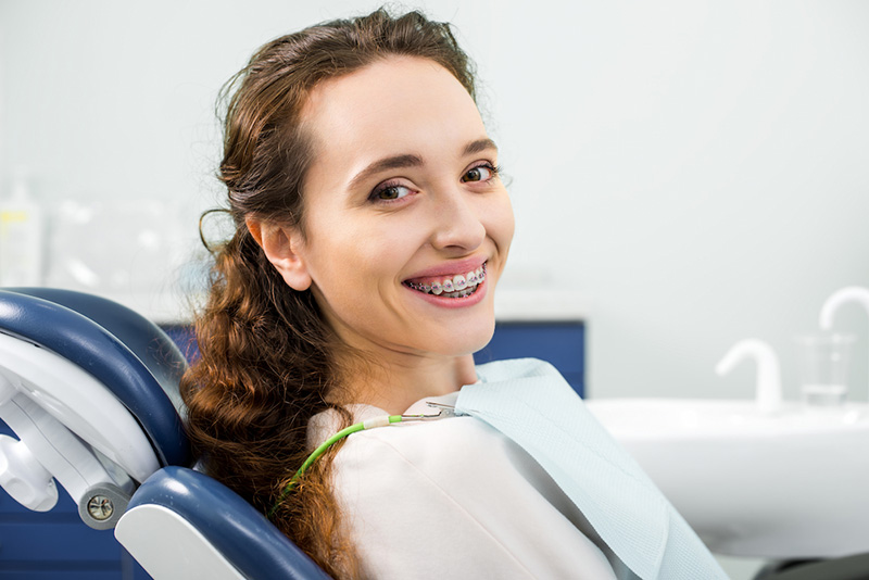 Happy Woman In Braces Smiling During Examination I Utc