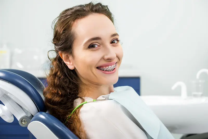 Happy Woman In Braces Smiling During Examination I Utc