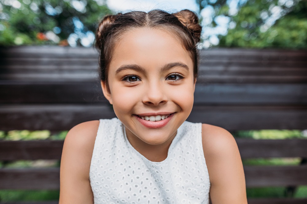 portrait of smiling child looking at camera while 2022 12 16 16 41 41 utc 1